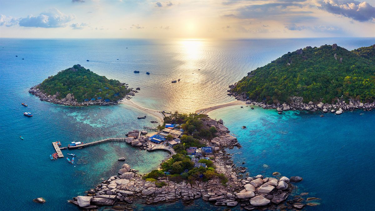 Aerial view of Koh Nangyuan in Surat Thani at sunset, three islands joined by a pale sandbar